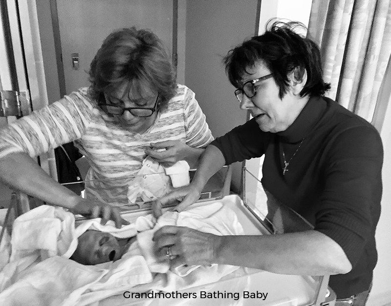 Grandmothers bathing stillborn baby